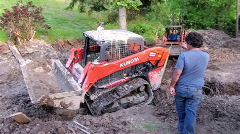 getting skid steer stuck to get out of work|skid steer rear end unstuck.